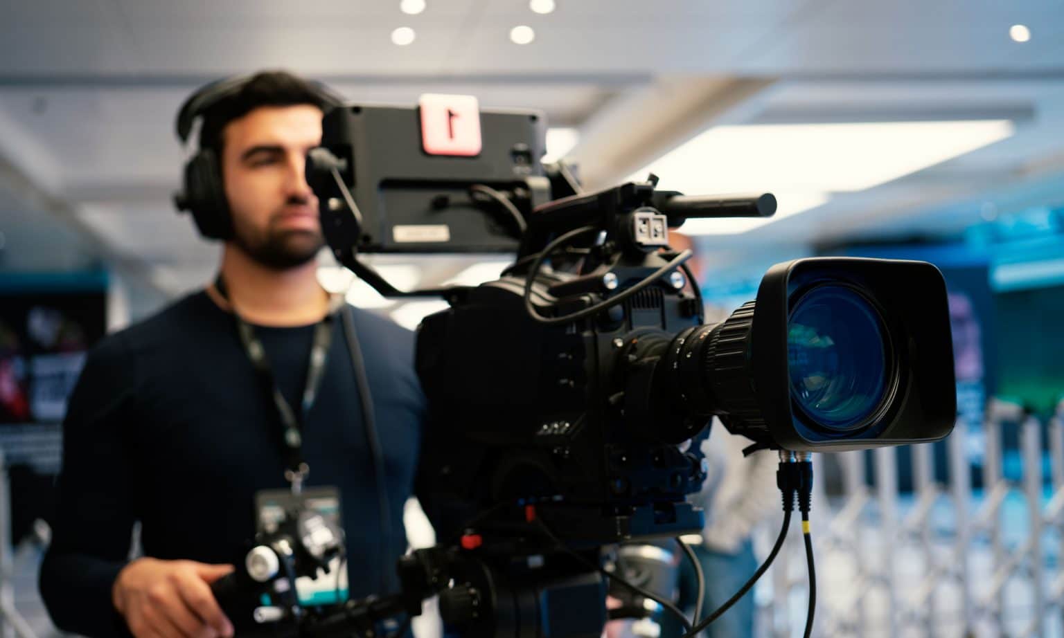 wypłata odszkodowania za sprzęt zadowolony filmowiec trzymający kamerę po wypłacie odszkodowania z uśmiechem